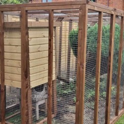 A very long catio with freestanding sleeping box